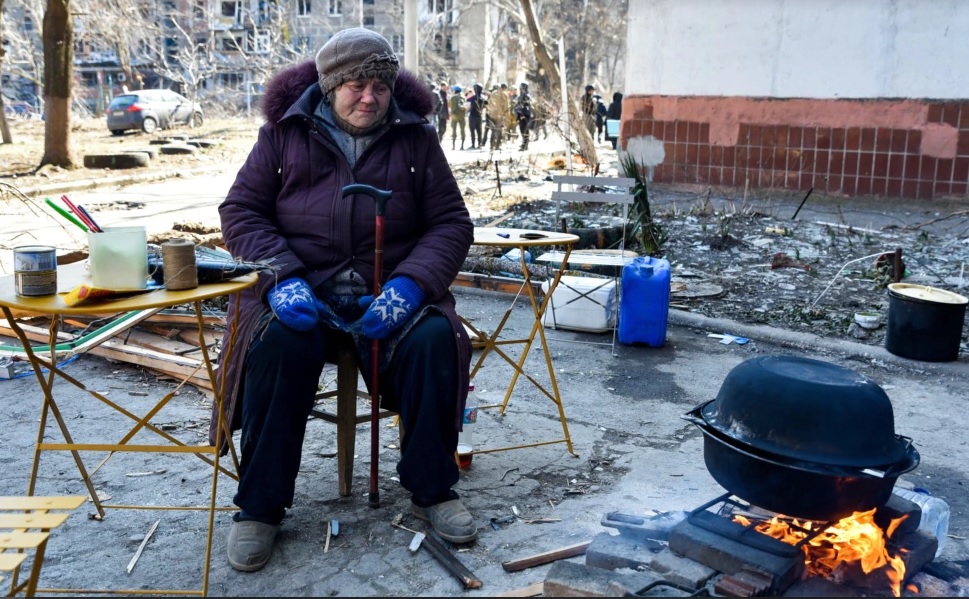 Femeie din Mariupol care topeşte zăpada pentru a avea apă de băut